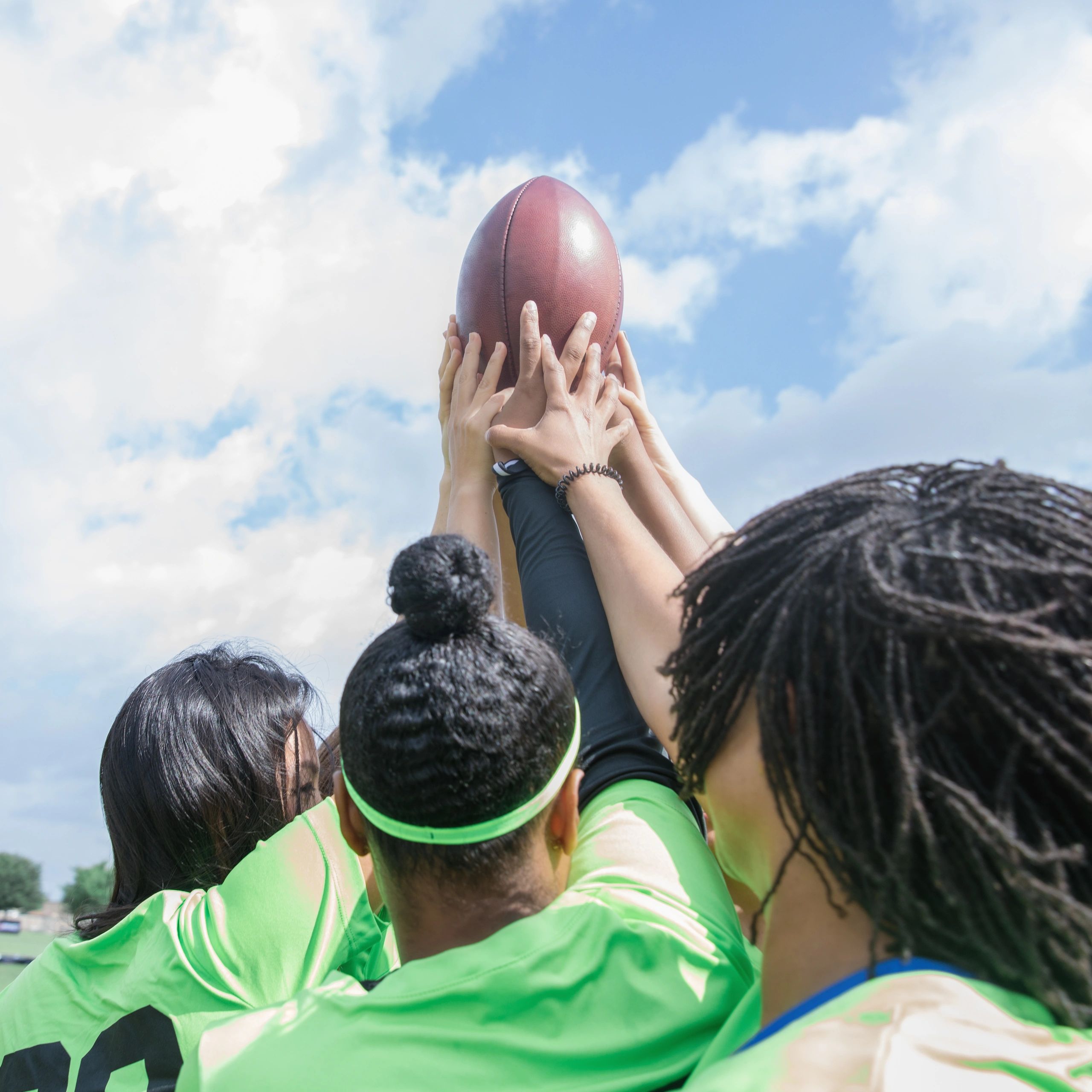 Girls flag football athlete running with the ball