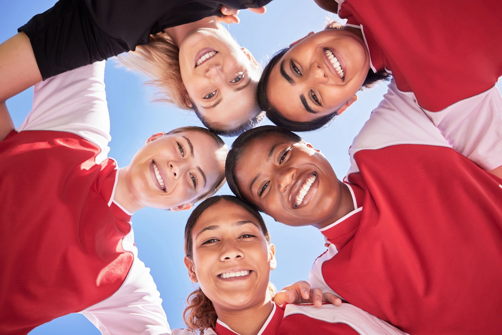 female athletes team huddle