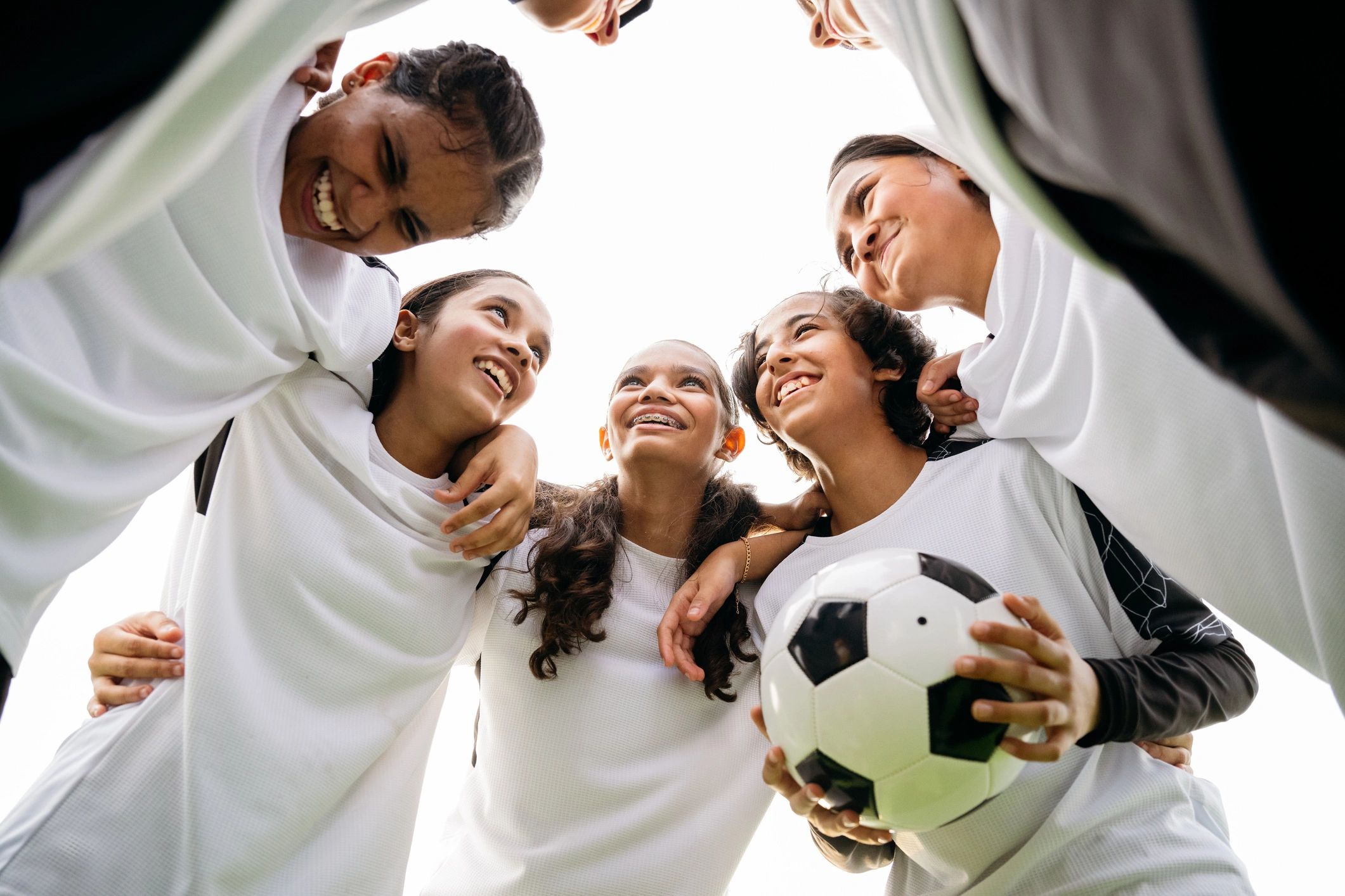 female athletes team huddle