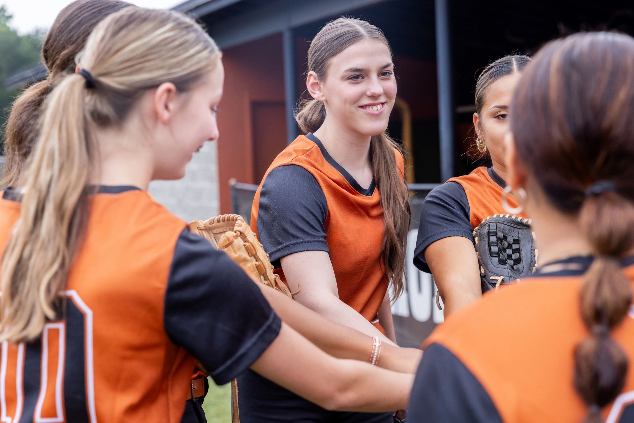female athletes team huddle